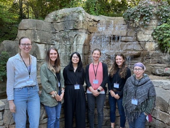 Members of the Penczykowski Lab pose for a group photo in front of a waterfall at the St. Louis Zoo.